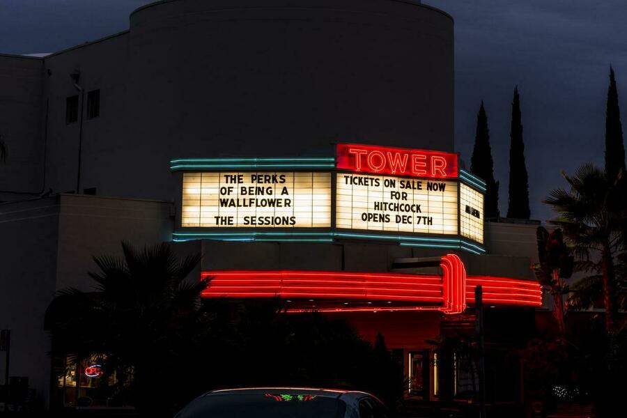 Neon marquee of the Tower Theatre in wiith red and green neon