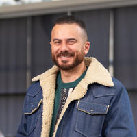 Writer-in-Residence Danny Ramadan in a jean jacket