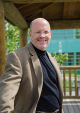 Dr. Keith Yeates smiles while standing outside