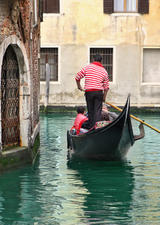 Venetian canal and gondola among old houses in Venice, Italy, Stock image