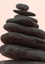 Stacked rocks against a pink sky