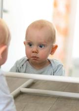baby looking in a mirror