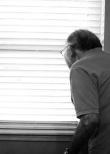 Elderly man by a window 