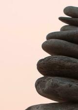 Stacked rocks against a pink sky
