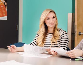 People read reports in a boardroom