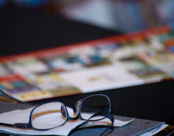 Glasses by a CDWP brochure. Photo by Monique de St. Croix.