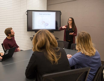 Supervisors and trainees talk in one of the training rooms