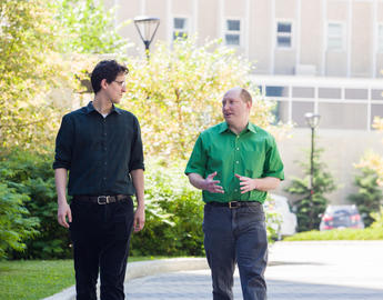 Two researchers walking around campus
