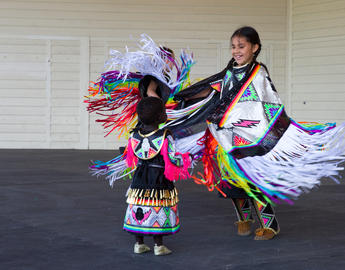 Indigenous children dancing together